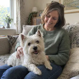 A small terrier at home with its owner